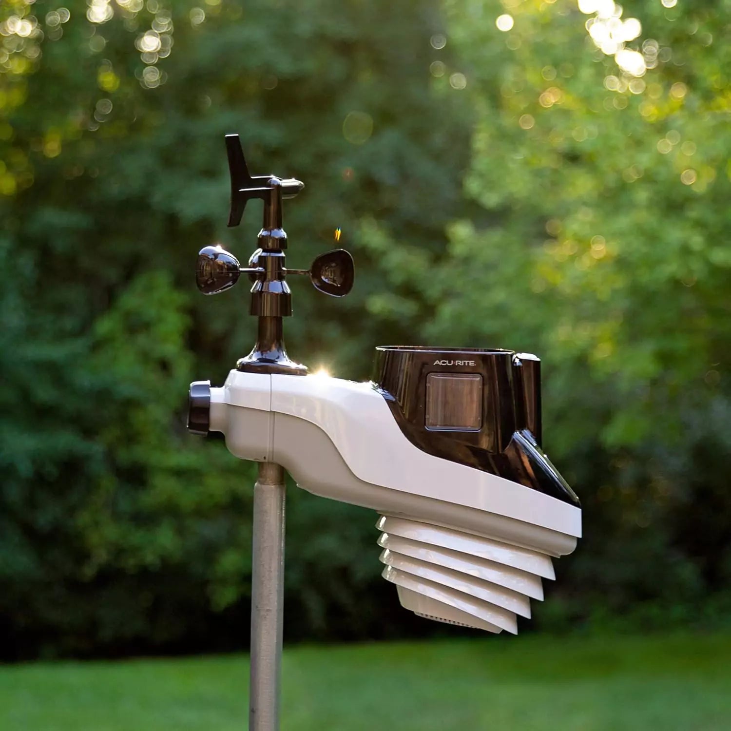 Acurite atlas weather station sensor mounted on a pole outdoors.