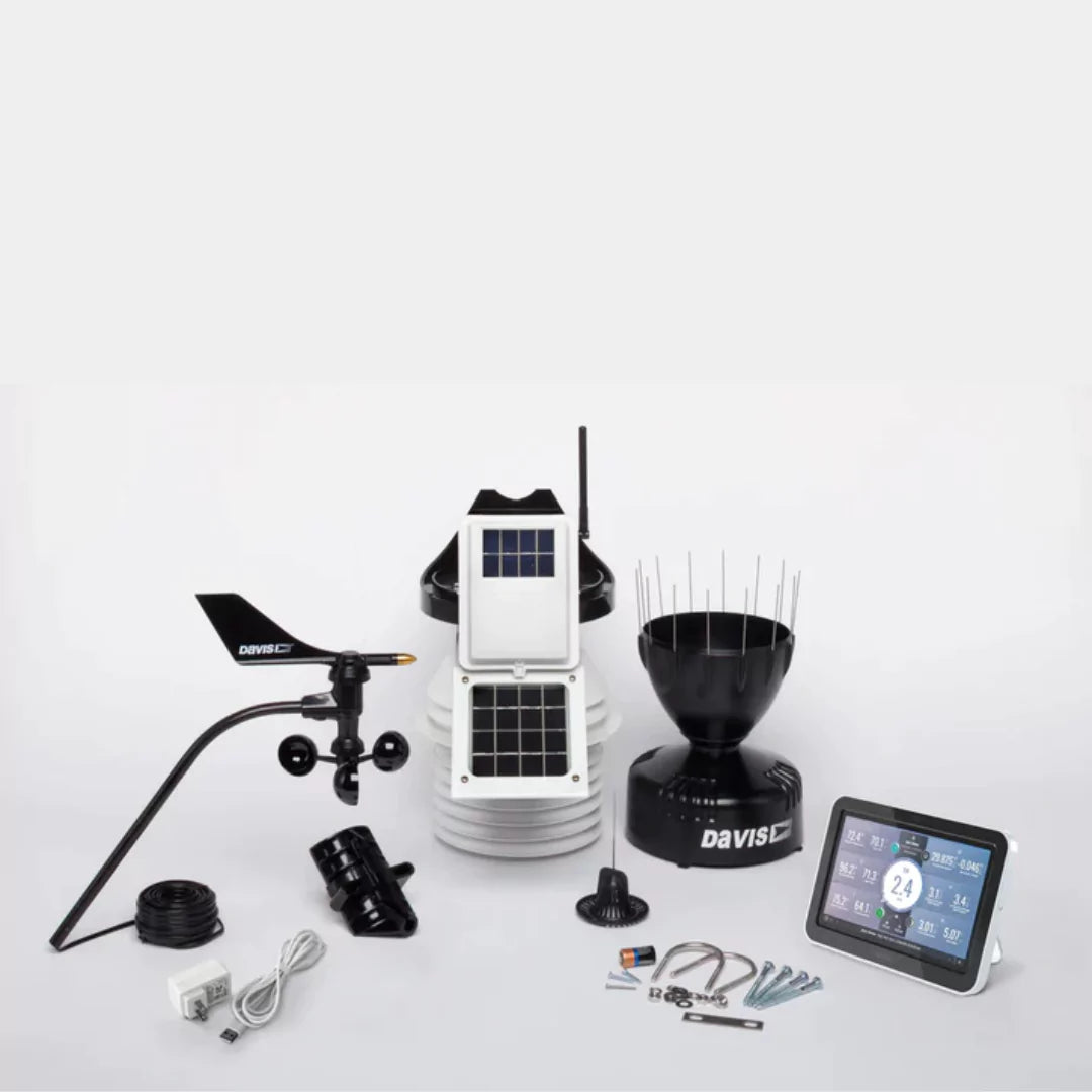 Unassembled Davis weather station components including console, sensors, and hardware.