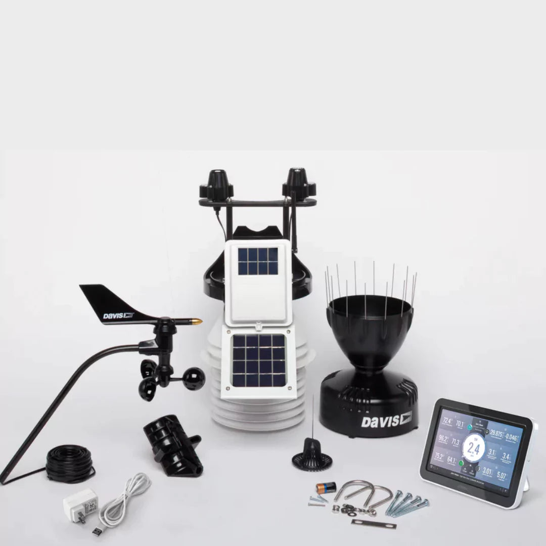 Unassembled Davis weather station components including console, sensors, and hardware.