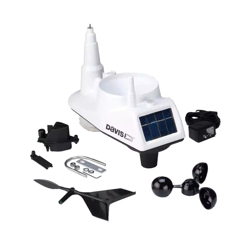 Davis Vantage Vue weather station unboxed showing anemometer, vane, sensors, and mounting accessories