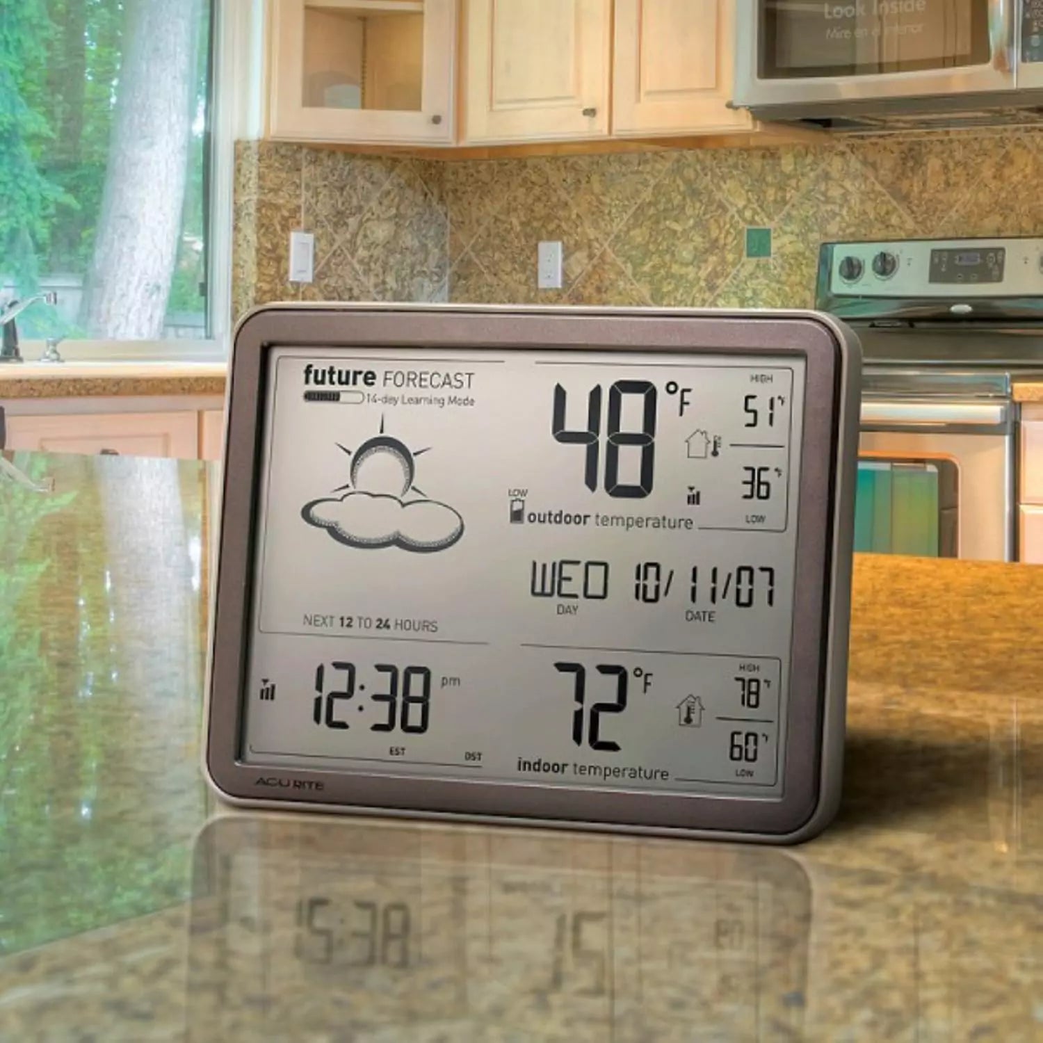 Acurite weather monitoring display placed in a kitchen.