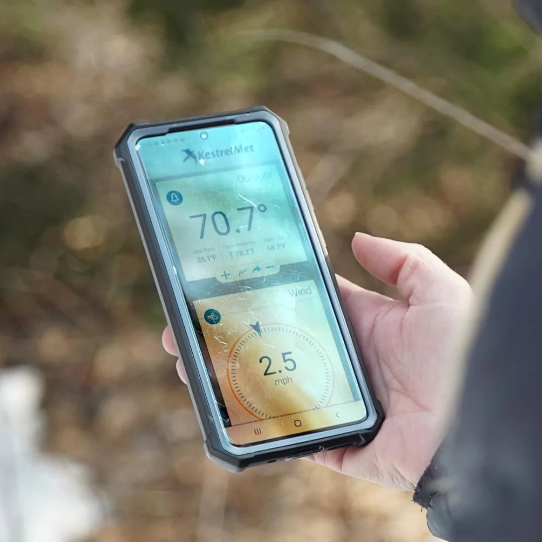 Hand holding phone showing weather data from KestrelMet 6000 app