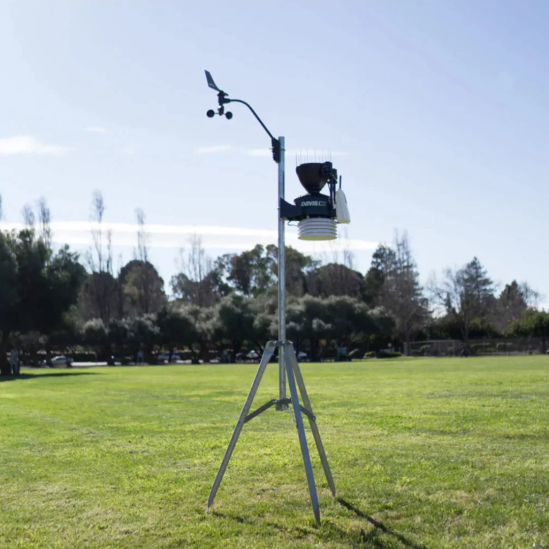 Outdoor setup of Davis Wireless vantage pro2 plus weather station on tripod stand in grassy field