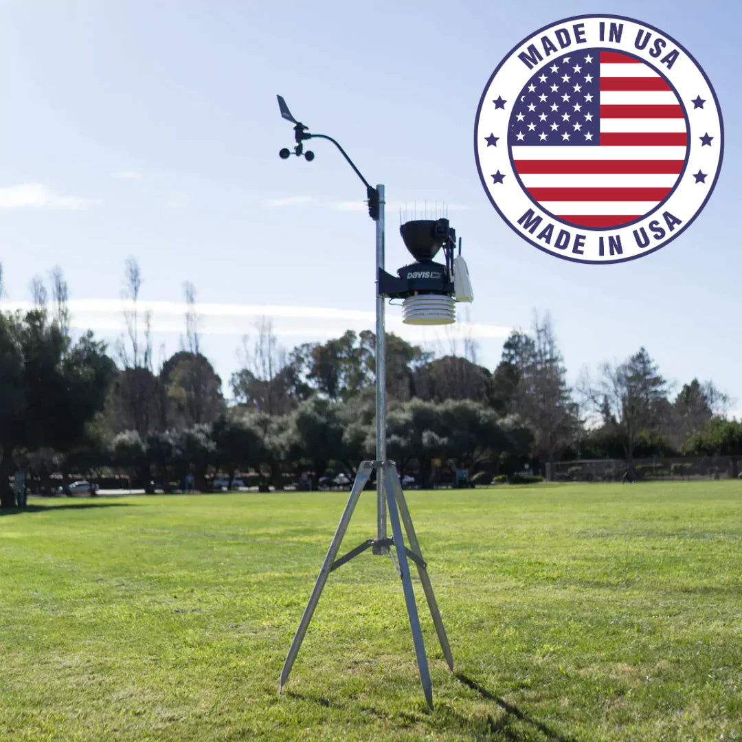 Davis weather station on tripod in grassy field with ‘Made in USA’ badge, representing American-made weather station collection.