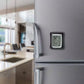 AcuRite Indoor Thermometer mounted on a refrigerator in a modern kitchen